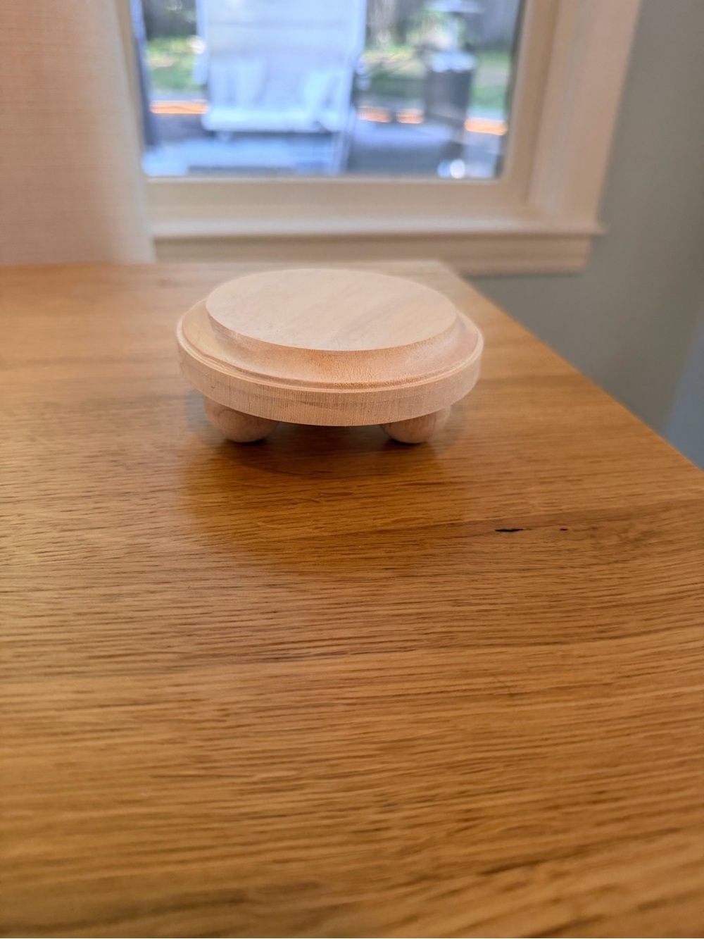 Small white circular figurine pedestal wooden